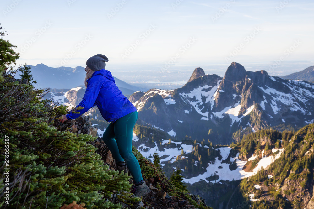Naklejka premium Adventurous woman hiking in the mountains during a sunny summer day. Taken on Mount Brunswick, Lions Bay, North of Vancouver, BC, Canada.