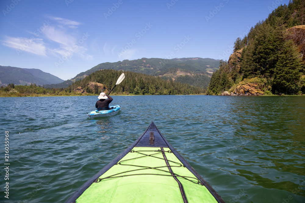 Kayaking in Harrison River during a beautiful and vibrant summer day. Located East of Vancouver, British Columbia, Canada.