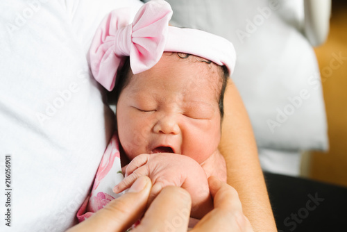 Close up of father holding newborn