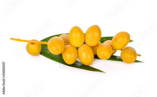 bunch of fresh yellow dates with leaf on white background
