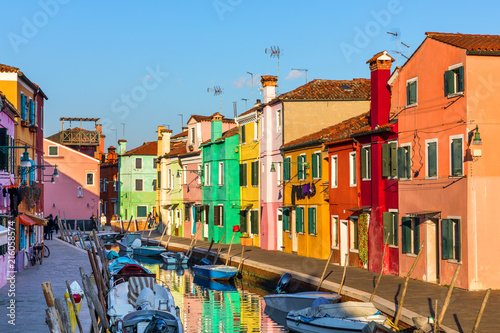 Beautiful view of the canals of Burano with boats and beautiful  colorful buildings. Burano village is famous for its colorful houses. Venice  Italy.