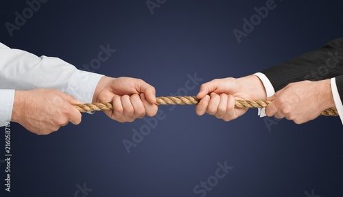 Business people pulling rope in opposite directions © BillionPhotos.com