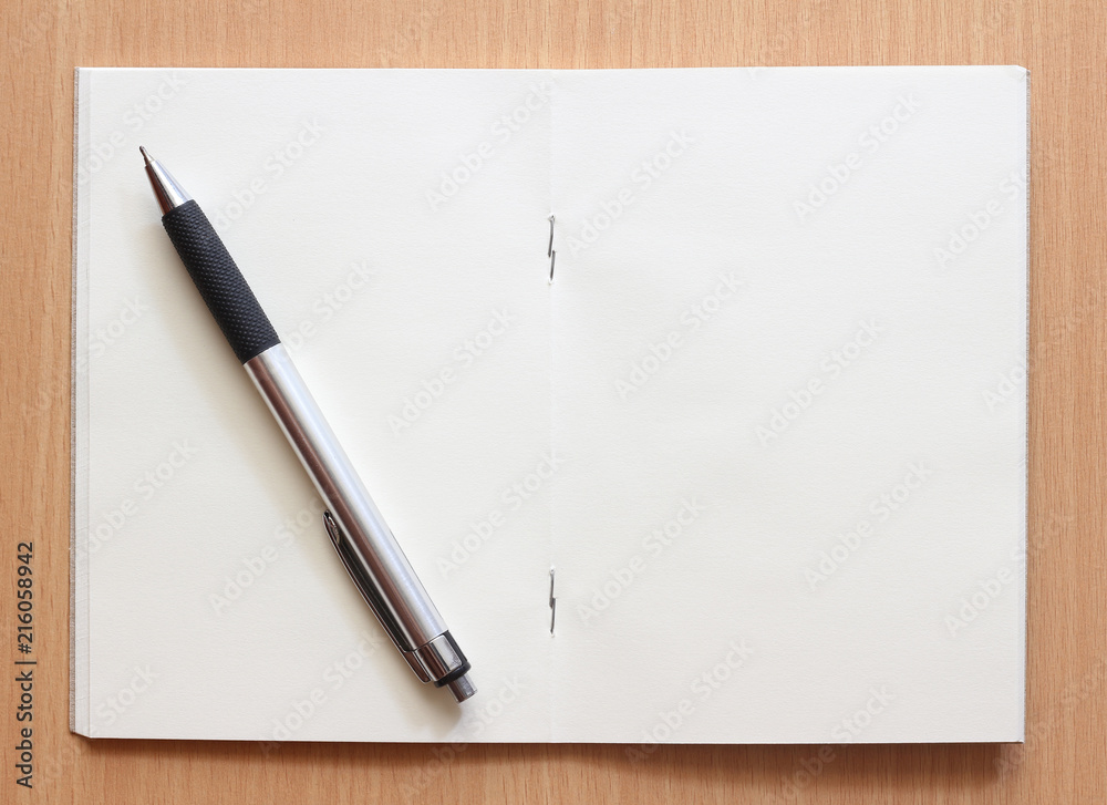 Pen and Notepad on the wooden background Pen and Notepad on the wooden background