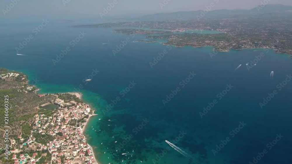 Aerial shot above the island Spetses in Saronic gulf of Greece. View of the city and the port. Slow rotation following the whole island perimeter. Lift off and landing movement. Aerial shot above the island Spetses in Saronic gulf of Greece. View of the city and the port. Slow rotation following the whole island perimeter. Lift off and landing movement.