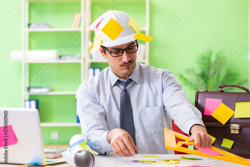 Male engineer working on new project with many conflicting prior