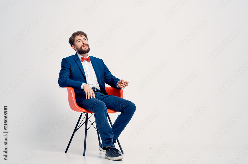 man in a suit sitting on with