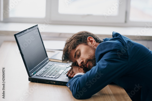 business man tired of sleeping at the laptop