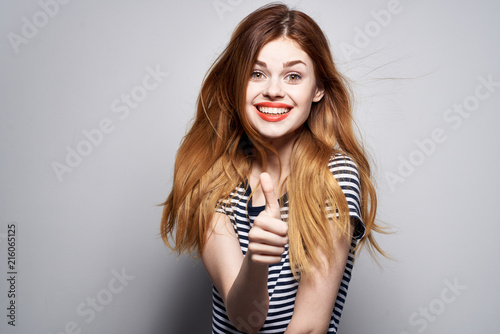 smiling woman showing thumbs up