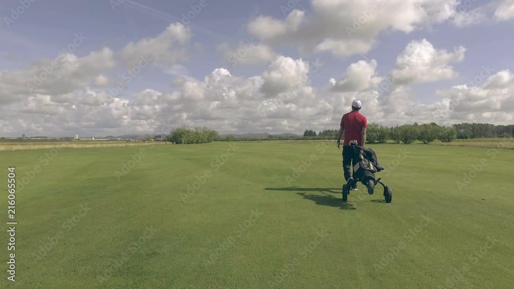 Golfer Walking Across Huge Course Golfer Walking Across Huge Course