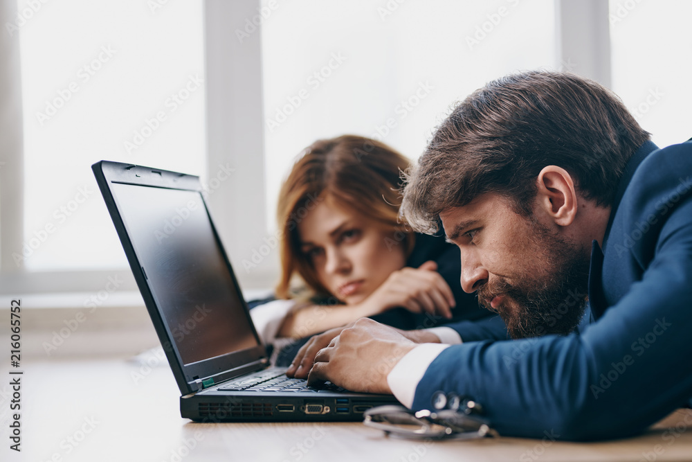 business colleagues are looking at a laptop business colleagues are looking at a laptop