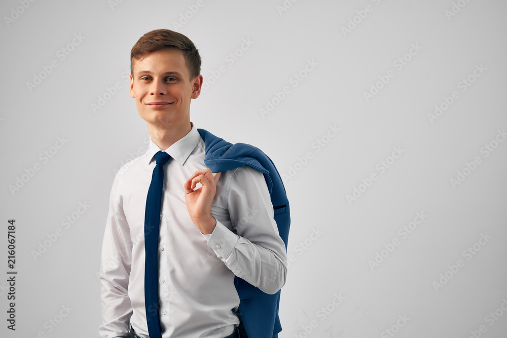 business man holding a jacket behind his back business man holding a jacket behind his back