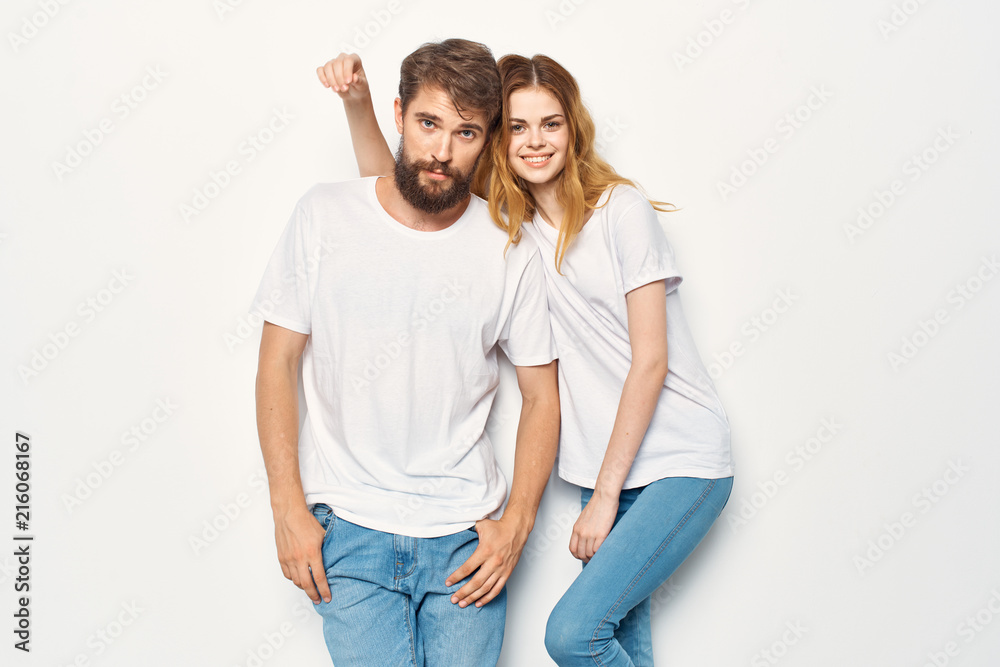 young couple in white T-shirts on a light background logo young couple in white T-shirts on a light background logo
