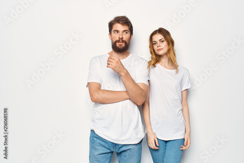 young couple in white t-shirts logo man with a beard woman with flowing hair