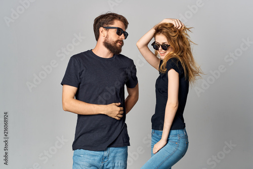 stylish young couple in glasses in black t-shirts logo fashion