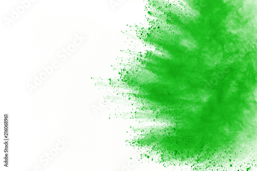 Green powder explosion on white background. Colored cloud. Color dust explode. Paint Holi.