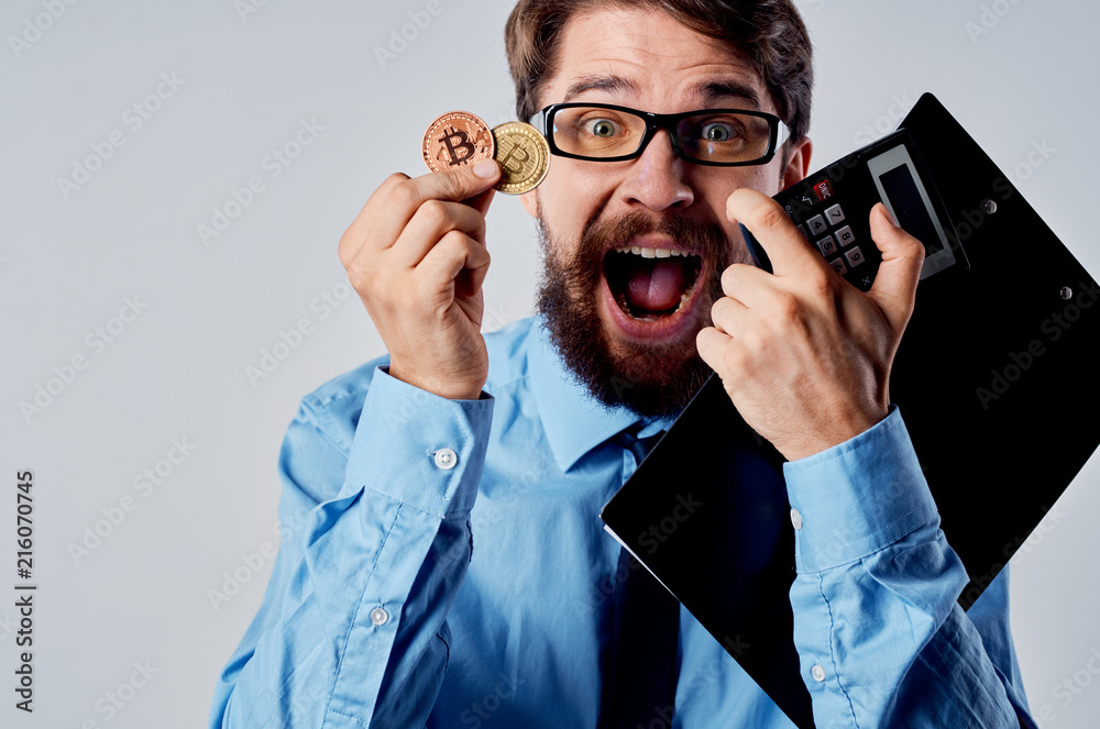 joyful business man with a bitcoin calculator joyful business man with a bitcoin calculator