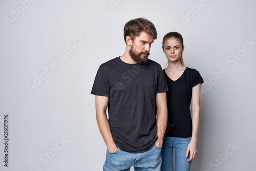young couple in black logo shirts