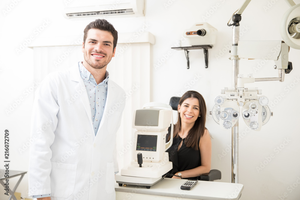Portrait of beautiful woman and handsome optician in clinic