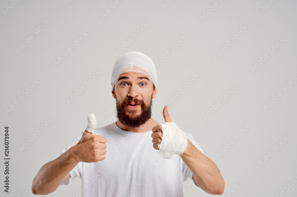 a man fell bandages on his head on the fingers of a wound a man fell bandages on his head on the fingers of a wound