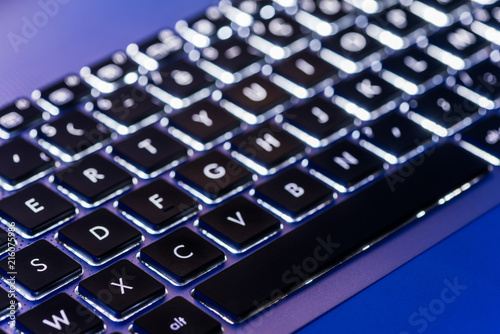 Backlit keyboard in a blue ambiant light photo