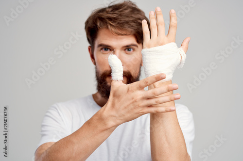 bandaged hands, a man with a beard