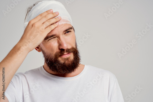 bearded man with bandaged head, operation