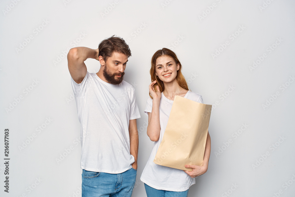 woman with a paper bag and a dumbfounded man woman with a paper bag and a dumbfounded man