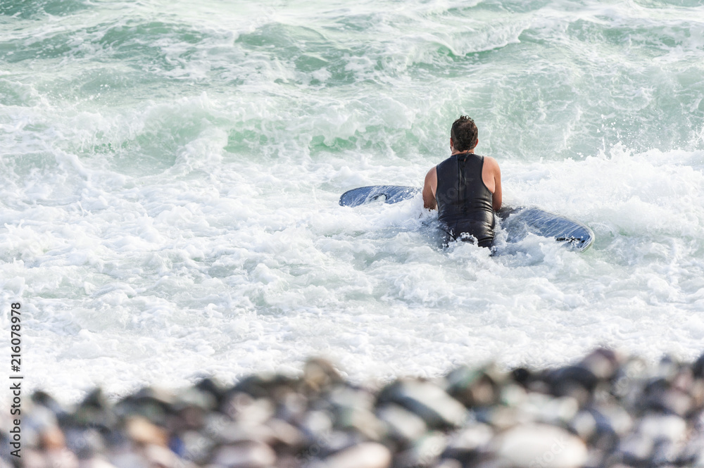 Surfer enjoying the waves on the beach near the district of Miraflores. Surfer enjoying the waves on the beach near the district of Miraflores.