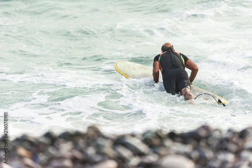 Surfer enjoying the waves on the beach near the district of Miraflores.