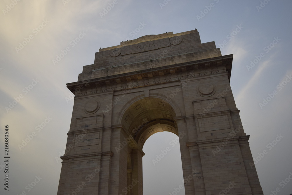 monument of india gate in delhi with cloudy sky