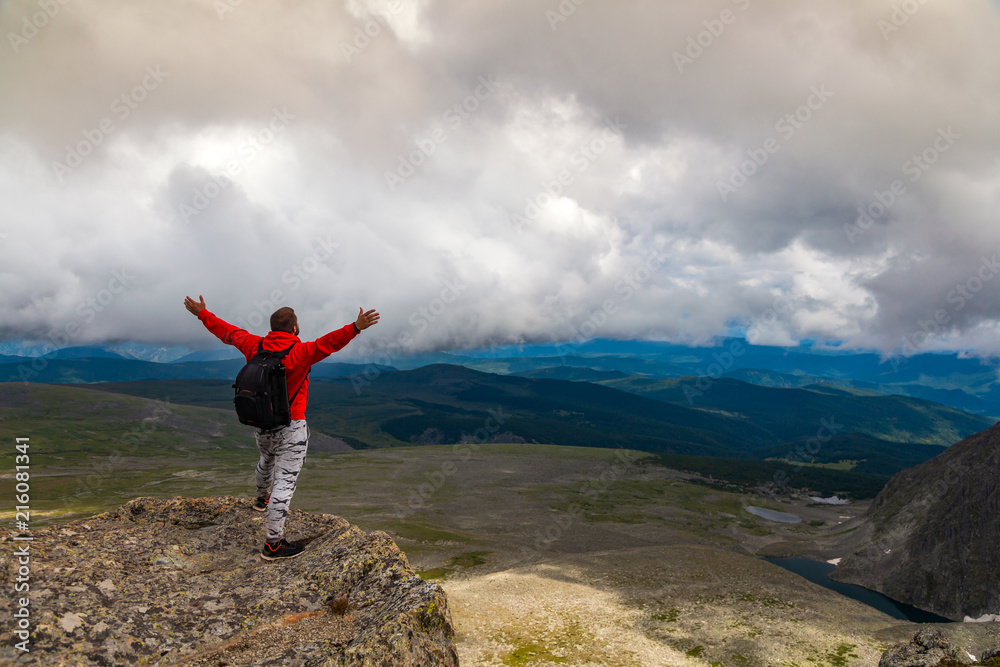 Man hiker enjoy the view at sunset mountain peak cliff.Photographer traveler on high mountaint Stylish man hiking. Travel Lifestyle and survival concept rear view Man hiker enjoy the view at sunset mountain peak cliff.Photographer traveler on high mountaint Stylish man hiking. Travel Lifestyle and survival concept rear view