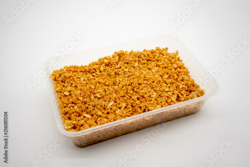 Deep fired garlic in clear plastic container isolated on white