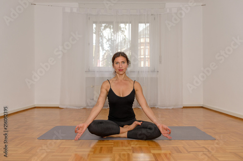 Attractive woman meditating alone in a room © michaelheim