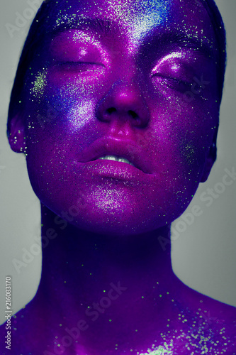 Woman space. A creative make-up of the person by means of bright paints and the poured pigments. Halloween, holidays, studio of beauty and art