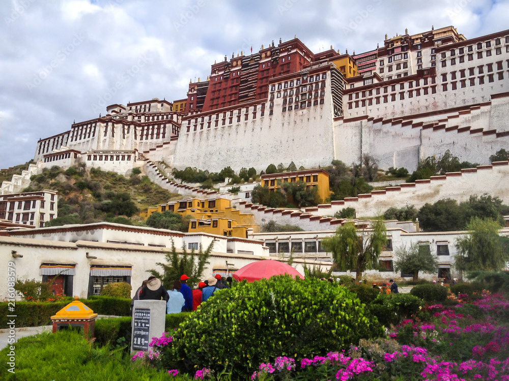 Potala Palace Front View with Garden in Lhasa, Tibet Autonomous Region. Former Dalai Lama residence, now is a museum and World Heritage Site.