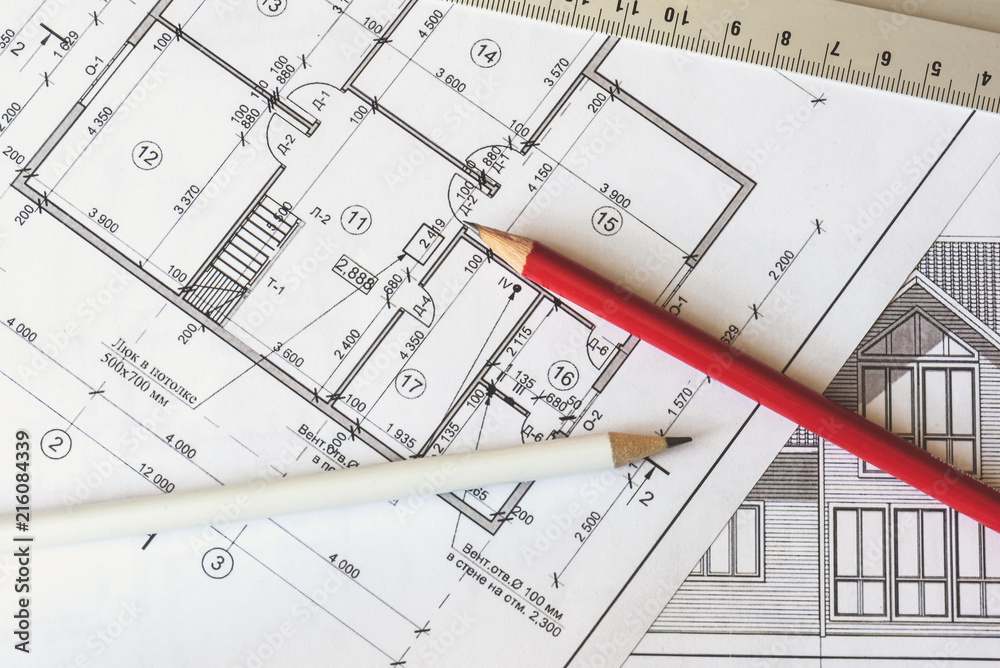 The architectural plan of the house is printed on a white sheet of paper. A red and white pencil on it. June 2018, Russia, Moscow The architectural plan of the house is printed on a white sheet of paper. A red and white pencil on it. June 2018, Russia, Moscow