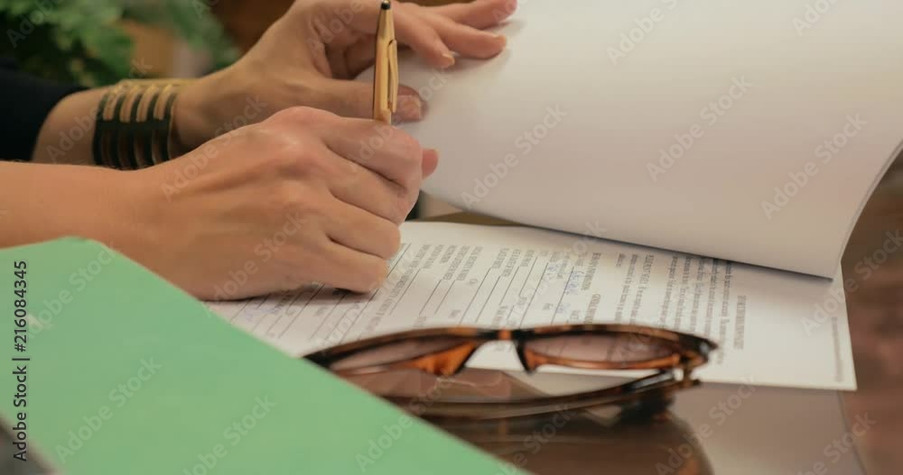 Girl signing document in an office