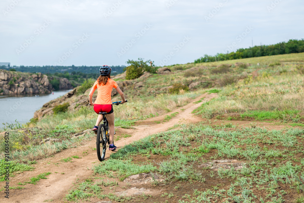 Young woman riding a mountain bike, an active lifestyle.