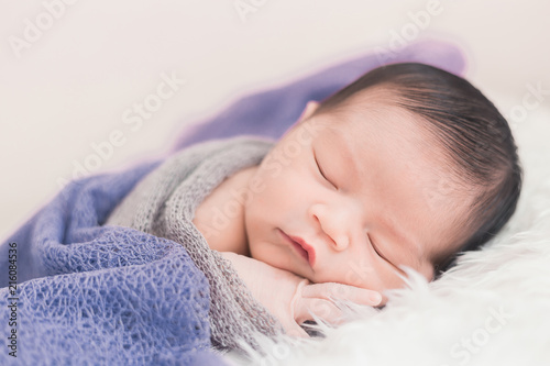 New born baby lying on a soft blanket. Cute new born baby in natural motion.