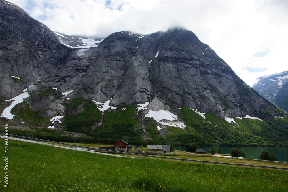 Big gray mountain in a green valley in Norway
