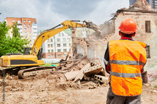 excavator crasher machine at demolition on construction site