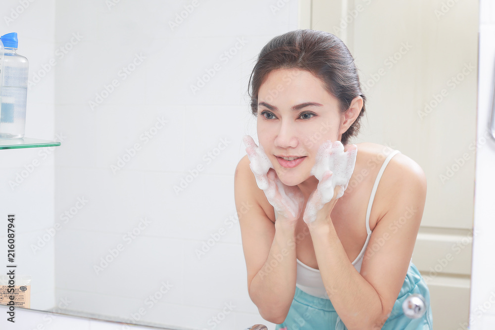 Asian woman cleaning face skin enjoy herself with bubble cleansing foam. Asian woman cleaning face skin enjoy herself with bubble cleansing foam.