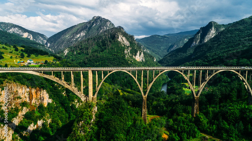 Aerial View of Durdevica Tara Arc Bridge in the Mountains, One of the Highest Automobile Bridges in Europe. photo