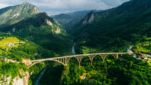 Aerial View of Durdevica Tara Arc Bridge in the Mountains, One of the Highest Automobile Bridges in Europe. photo