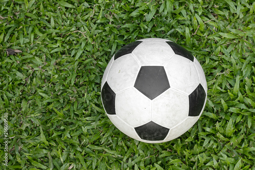 Soccer ball on green grass soccer field.