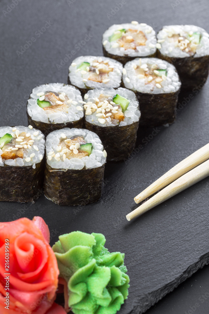 Japanese restaurant, sushi roll on black slate plate. Japanese restaurant, sushi roll on black slate plate.