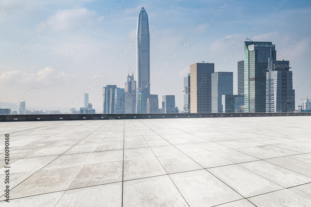 Panoramic skyline and modern business office buildings with empty road,empty concrete square floor Panoramic skyline and modern business office buildings with empty road,empty concrete square floor