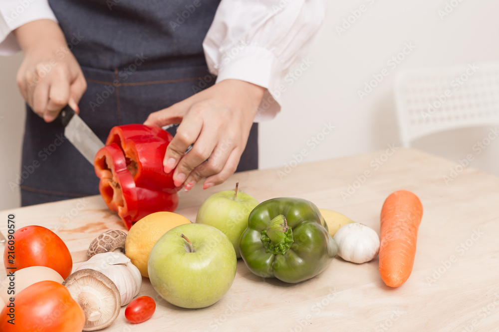 Young Woman Cooking Healthy Food and Vegetable Salad in the kitchen at home. Healthy Lifestyle. Young Woman Cooking Healthy Food and Vegetable Salad in the kitchen at home. Healthy Lifestyle.