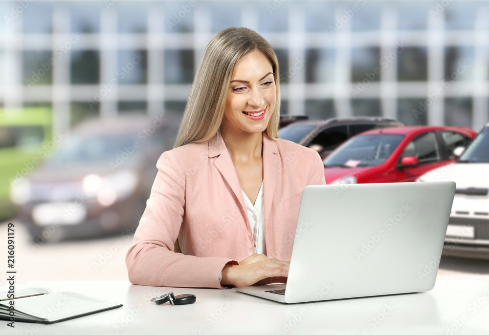 Woman working at table with laptop and car key isolated on white Woman working at table with laptop and car key isolated on white