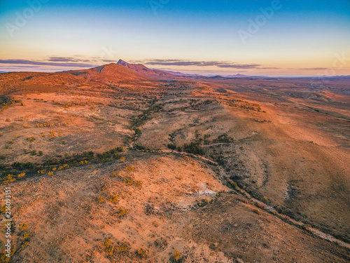 Red hills and rugged peak at sunset in Flinders Ranges, South Australia © Greg Brave